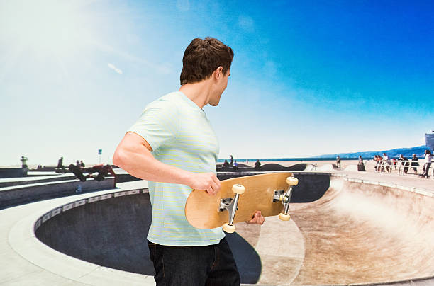 istock Man holding skateboard outdoors 533431236