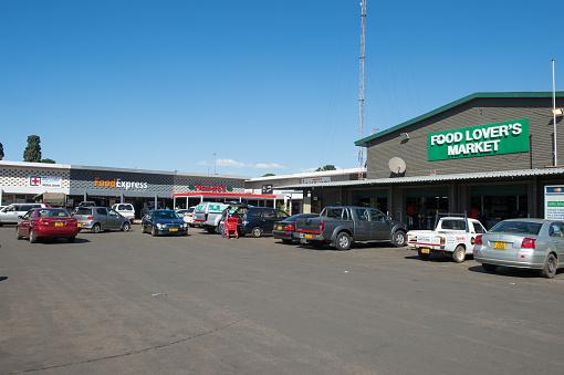 Harare, Zimbabwe - May 12, 2016: Zimbabweans shop at South African-based franchise retail outlets at a suburban shopping centre near Harare. The country recently adopted the US dollar as its currency after the inflation-driven demise of the Zim dollar, and is currently in the process of attamepting to re-adopt its own or an African currency but facing stiff resistance from its countrymen.