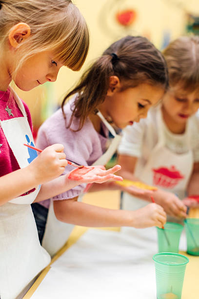 Children Painting Their Hands With Watercolors