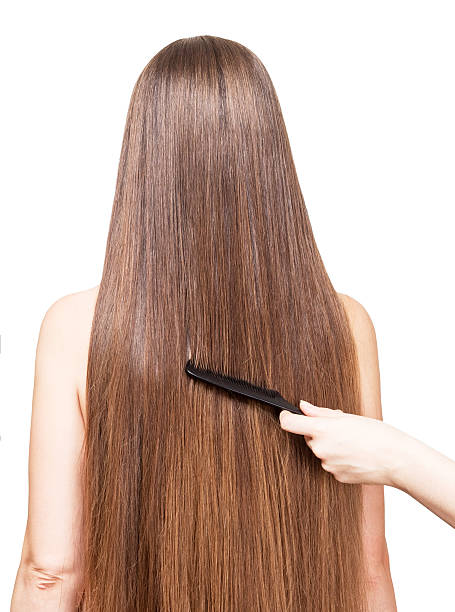 istock Barber's hand combing her long straight hair  on white 533433586