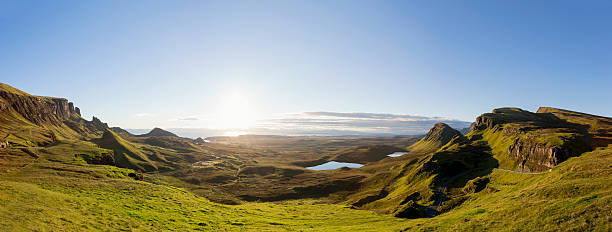 Panoramic Sunrise at the Quiraing on Isle of Skye Scotland Sunrise at the Quiraing on Isle of Skye, Scotland. Panoramic composite of 3 images scottish highlands stock pictures, royalty-free photos & images