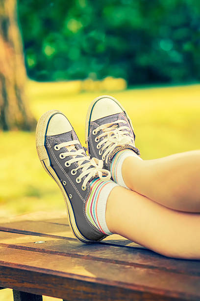 istock Woman's feet in a grey canvas sneakers 533435114