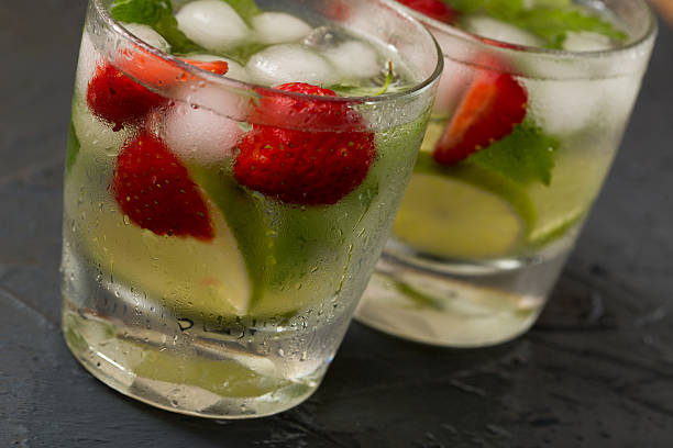 Refreshing summer cocktail with lime, strawberry and mint. Mojito cocktail, selective focus