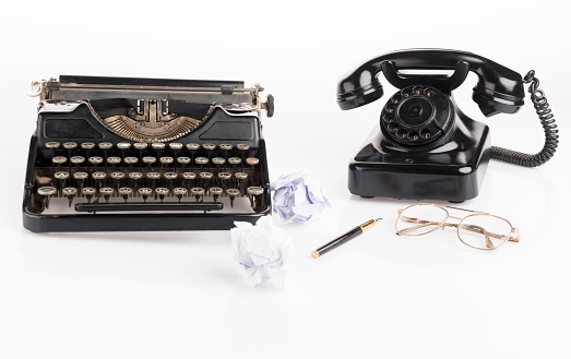 Vintage old typewriter and phone isolated on white 