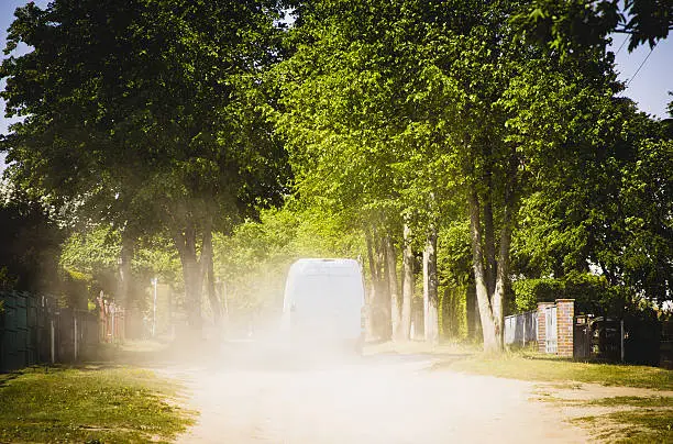 dusty road with transporter in german village