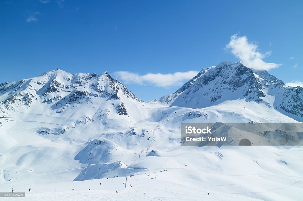 Winter snow Alps landscape with ski pistes Alpine resort of Les Arcs with ski slopes on snowy French Alps mountains Les Arcs Stock Photo