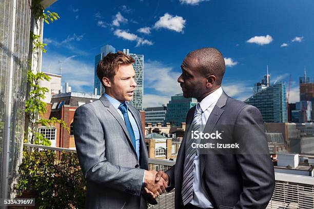 Two Businessmen Shaking Hand Outdoors Stock Photo - Download Image Now - African Ethnicity, African-American Ethnicity, Financial Occupation