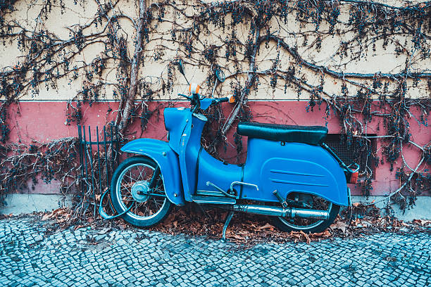 istock Single moped leaning against wall with vines 533440490