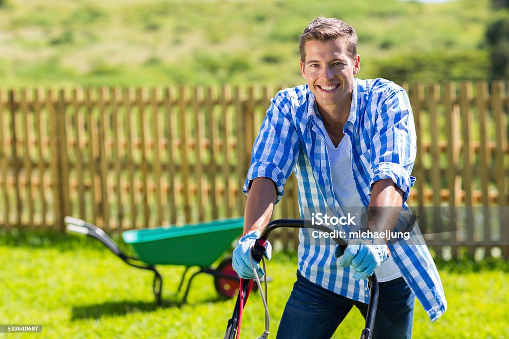 happy man mowing lawn happy man mowing lawn at home garden Mowing Stock Photo