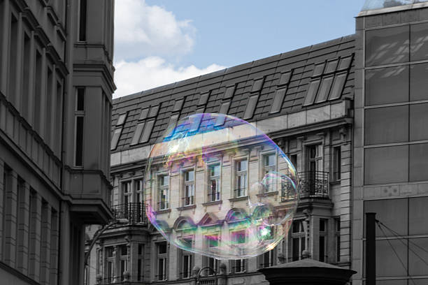 real estate bubble, concept - soap bubble and building facade
