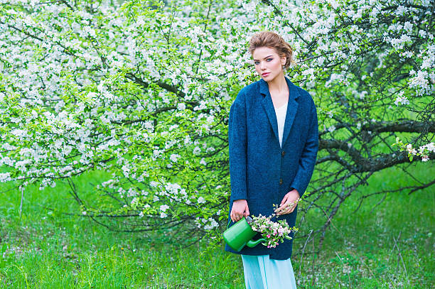 Woman in blooming spring garden