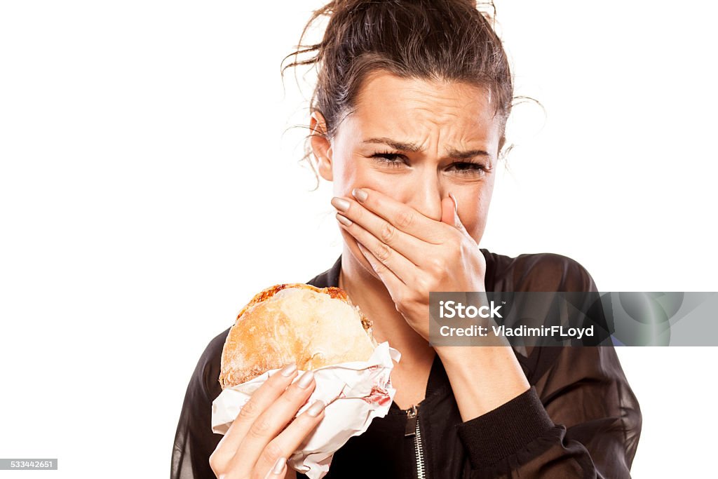 Beautiful girl is disgusted by her sandwich beautiful girl is disgusted by her sandwich Food Stock Photo