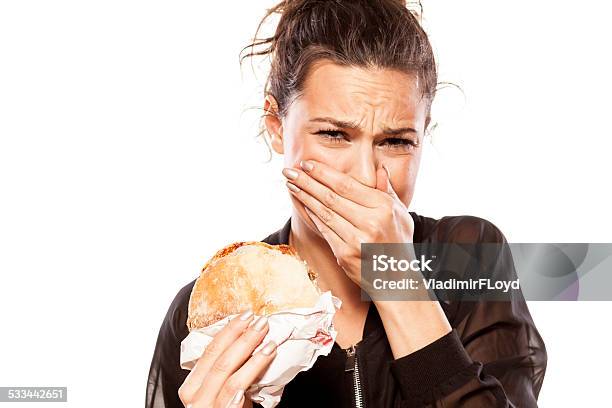 Beautiful Girl Is Disgusted By Her Sandwich Stock Photo - Download Image Now - Food, Unpleasant Taste, Disgust