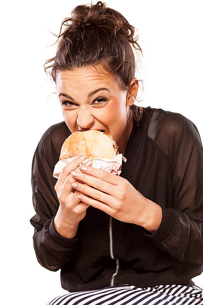 istock Beautiful girl voraciously eating her sandwich 533442673
