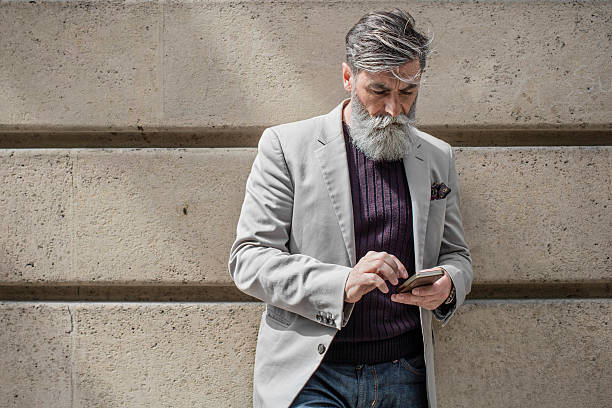 Senior man sending a mobile phone message