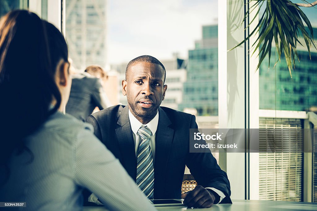 Job interview Young woman having job interview in an office, talking with manager. Human Resources Stock Photo