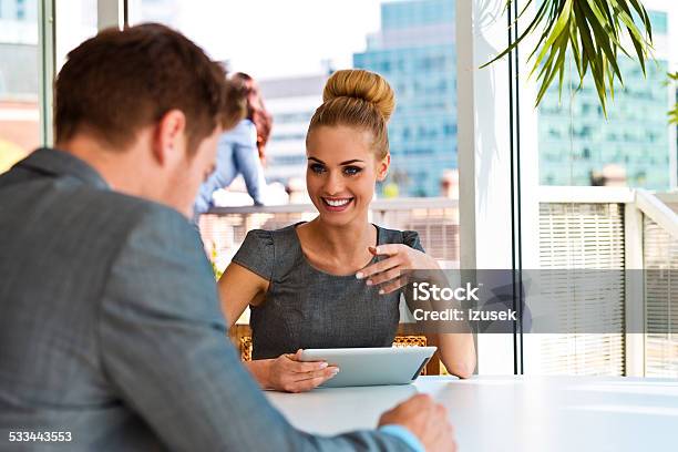 Businesswoman Talking With Her Business Partner Stock Photo - Download Image Now - 2015, Adult, Agreement
