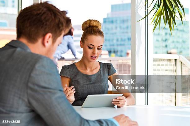 Businesswoman Talking With Her Business Partner Stock Photo - Download Image Now - Business, E-Reader, Reading