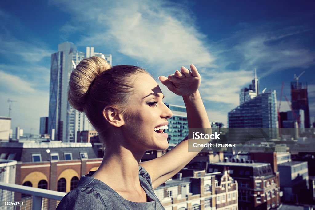 Successful businesswoman, Outdoor Portrait Outdoor portrait of happy businesswoman looking in the distance with city scape in the background. 2015 Stock Photo