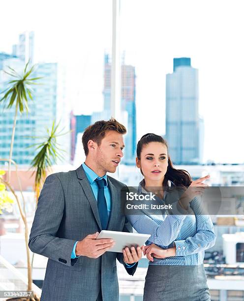 Business Couple Discussing In An Office Stock Photo - Download Image Now - Real Estate Agent, Businessman, Cityscape