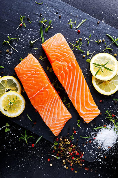 istock fresh raw salmon fillet with aromatic herbs, spices. 533444078
