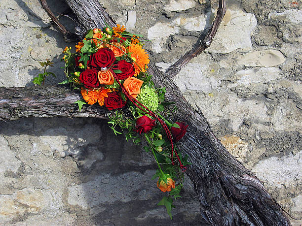 A beautiful wedding flower bouquet placed on an old vine plant.