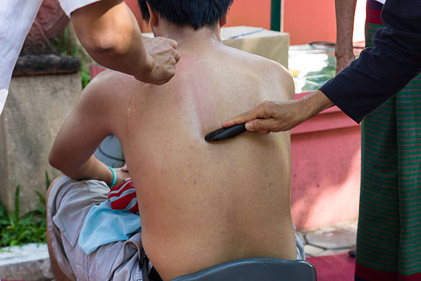 Woman during Chinese traditional massage - Gua Sha. Alternative medicine, body care and wellness