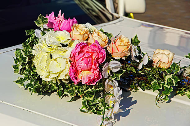 istock Decorative flowers bouquet on white wedding car. 533446656