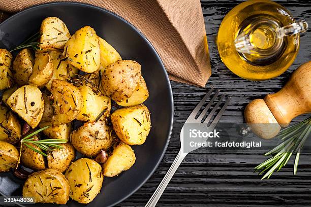 Roasted Potatoes Stock Photo - Download Image Now - Roasted Potatoes, Prepared Potato, Plate