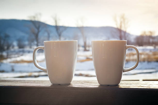 istock two hot chocolate cups outdoors 533449336