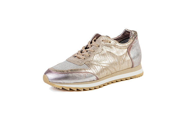 istock gold and silver women's sneakers on a white background 533449536