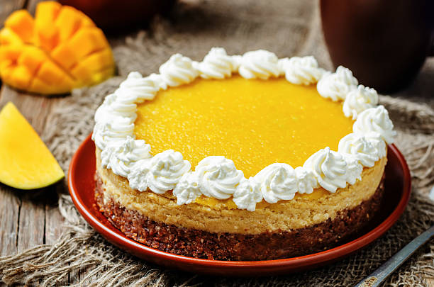 istock mango cheese cake decorated with whipped cream and mango puree 533453666