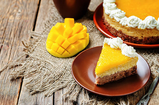 istock mango cheese cake decorated with whipped cream and mango puree 533453930