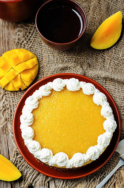 istock mango cheese cake decorated with whipped cream and mango puree 533453950