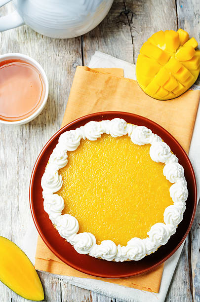 istock mango cheese cake decorated with whipped cream and mango puree 533453968