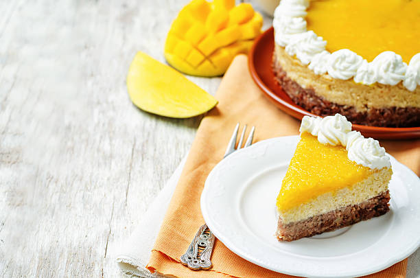 istock mango cheese cake decorated with whipped cream and mango puree 533453988