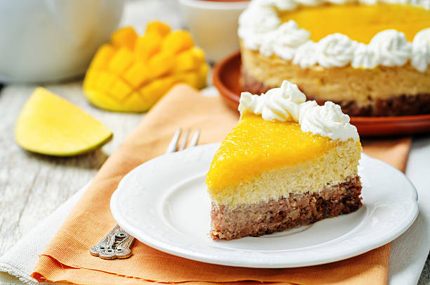 istock mango cheese cake decorated with whipped cream and mango puree 533454000
