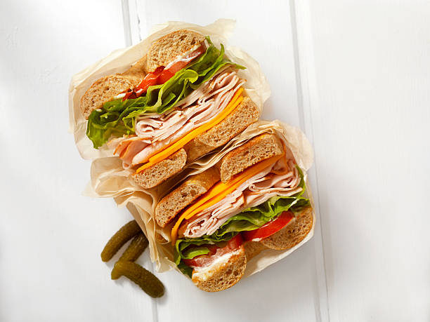 Deli Style Turkey Bagel Sandwich Deli Style Turkey Bagel Sandwich with Cheddar Cheese, Lettuce,Tomato and Mayo - Photographed on a Hasselblad H3D11-39 megapixel Camera System delicatessen stock pictures, royalty-free photos & images