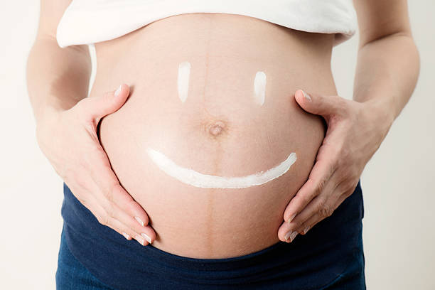 istock Smiling Face on Pregnant Womans Belly 533454942