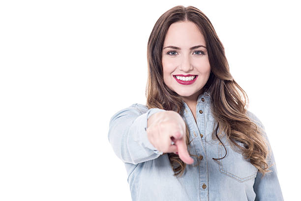 istock Happy young lady pointing at you 533457922