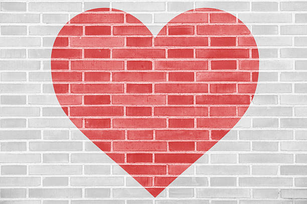 istock Red heart silhouette on a brick wall 533457926