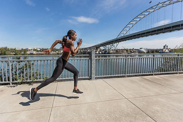 istock Attractive ethnic female sprinter training in the city 533459008