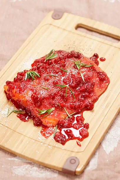 Salmon steak marinated in salt with redberries and rosemary