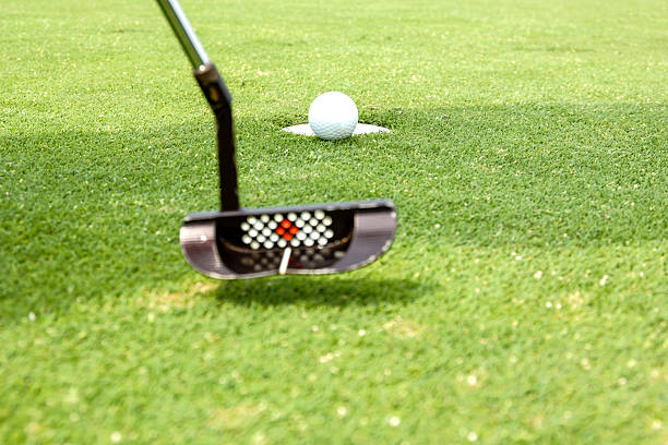 istock Playing Golf - Putting the ball into the hole. 533459295