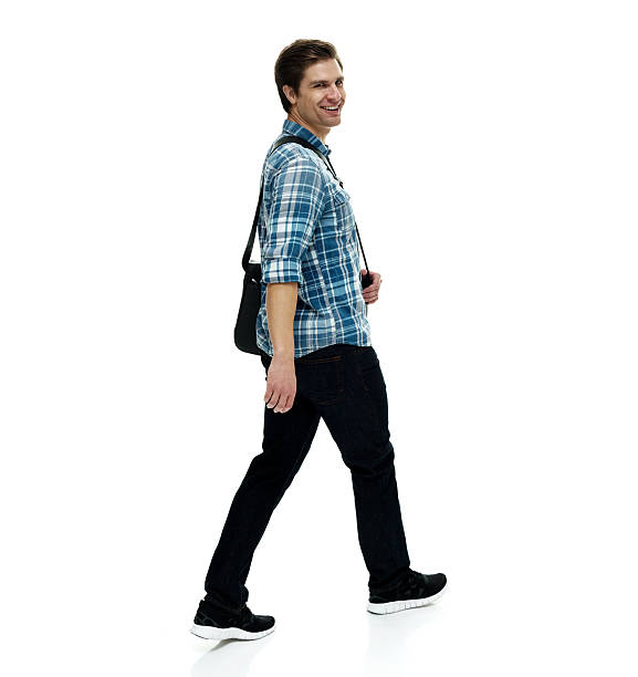 istock Smiling casual man walking and looking at camera 533459476