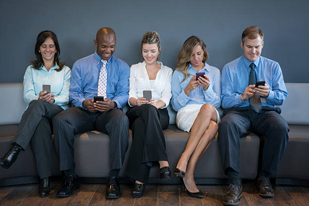 istock People social networking on their phones at the office 533459634