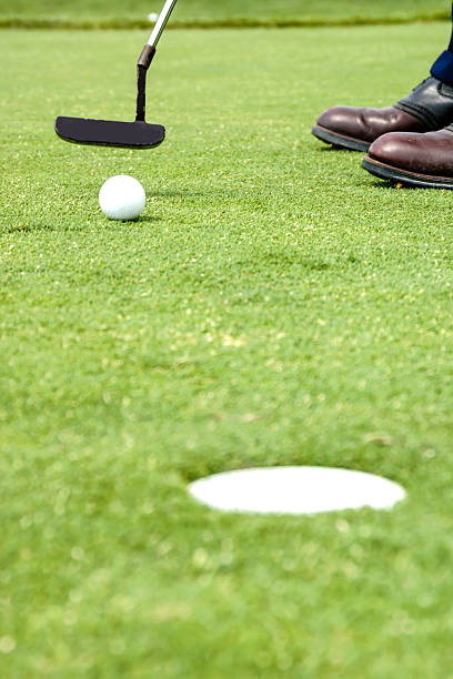 istock Playing Golf - Putting the ball into the hole. 533460061