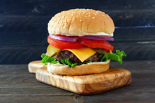 istock Classic hamburger on a paddle board over dark wood 533460150
