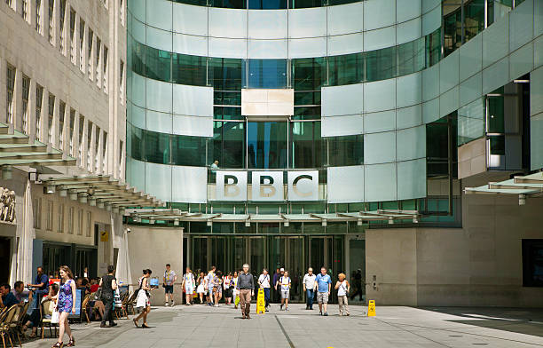 BBC head office, London London, UK - July 3, 2014:  BBC head office and square in front of main entrance with walking people bbc photos stock pictures, royalty-free photos & images