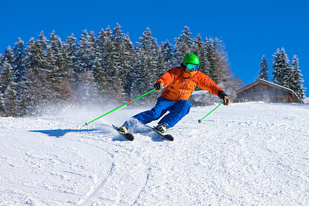 istock Man skiing fast downhill on sunny day in the Alps 533461147
